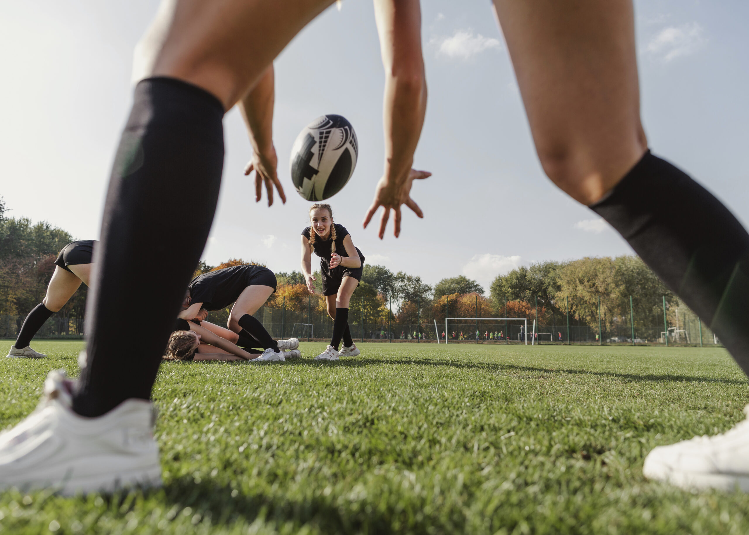 back view women hands trying catch rugby ball